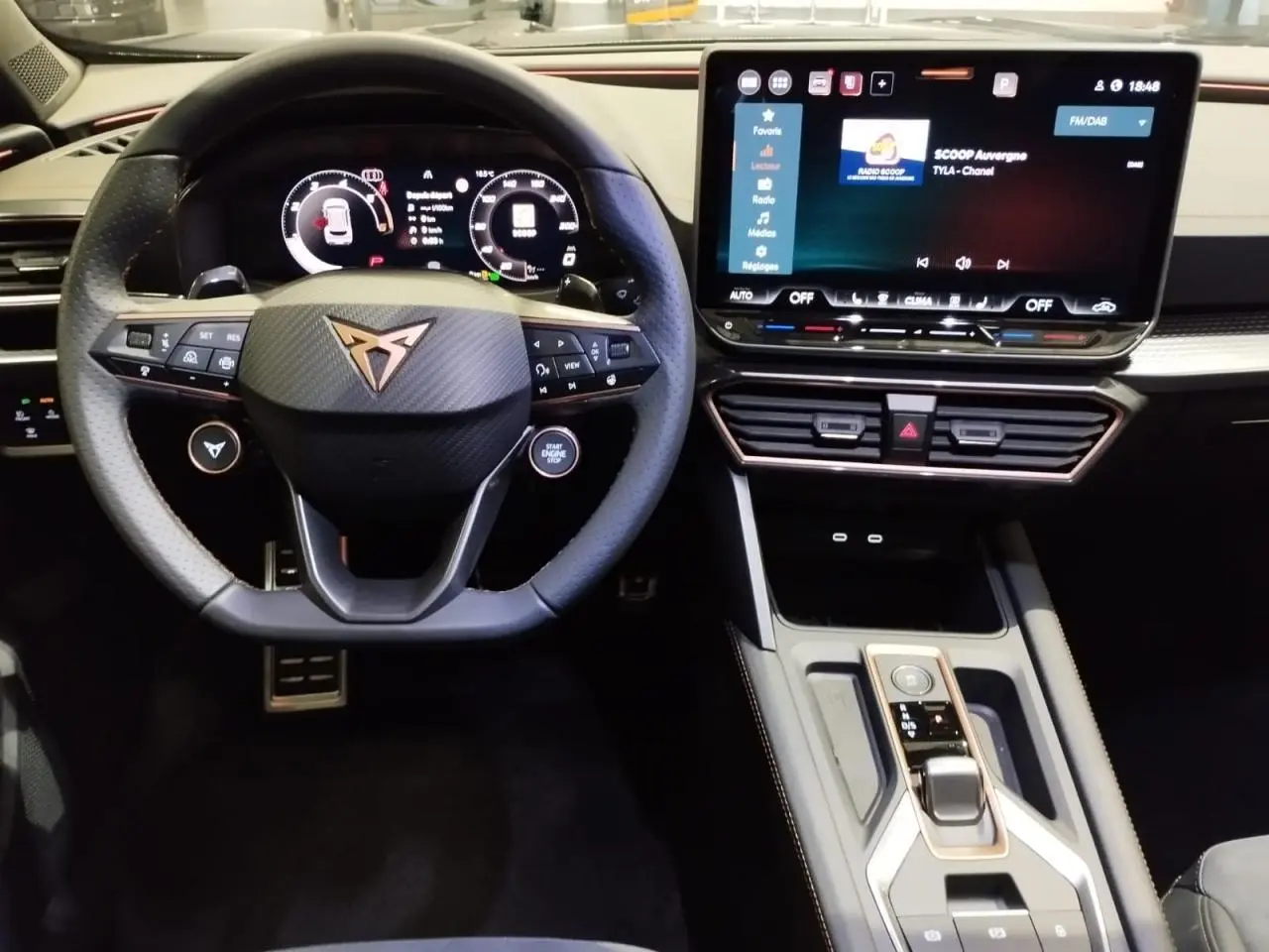 Vue intérieure centrée sur le volant Cupra noir et carbone, avec tableau de bord digital et écran tactile HD du Formentor 2026.