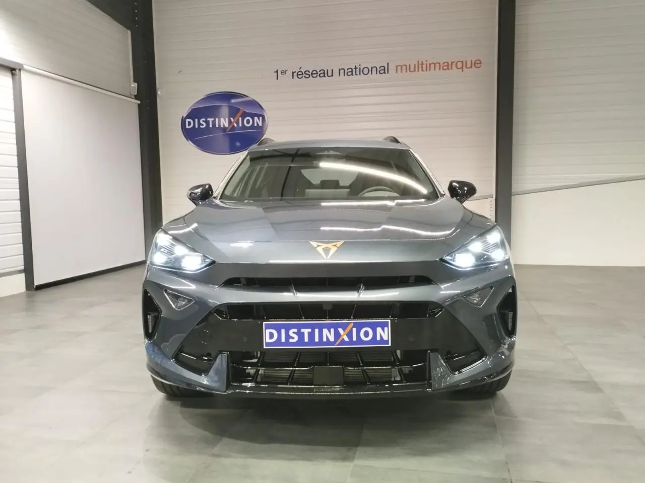 Vue avant d'un CUPRA Formentor 2.0 TDI 150 DSG 7 en gris Magnetic Tech avec logo CUPRA lumineux au centre du capot.