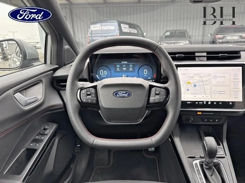 Vue intérieure centrée sur le volant multifonction et tableau de bord digital du Ford Puma gris Solar 2025.