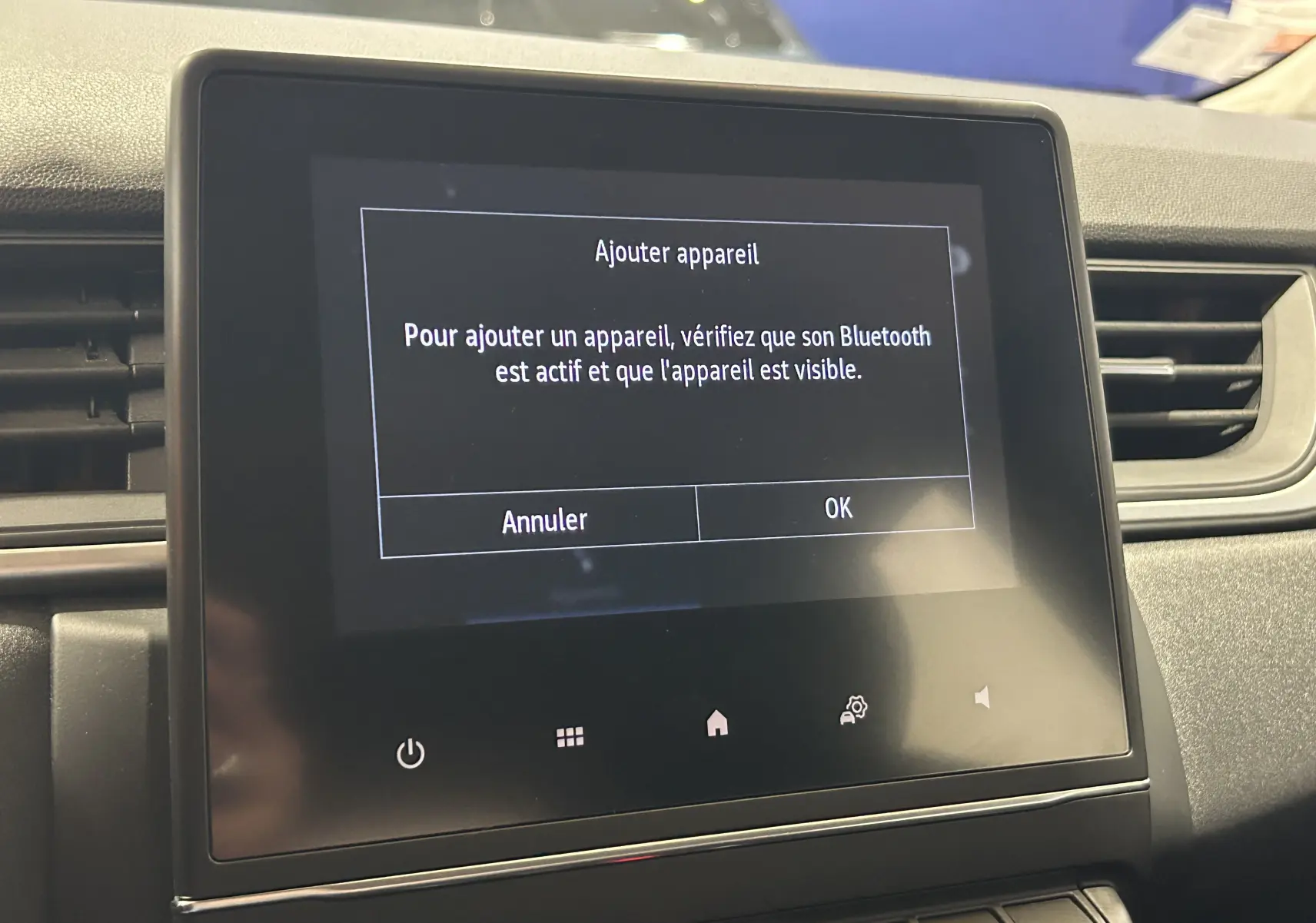 Écran tactile central du tableau de bord du Renault Captur gris 2022 affichant un message Bluetooth.