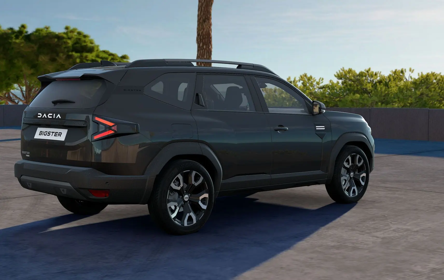 SUV Dacia Bigster noir nacré en 3/4 arrière droit, avec feux arrière en forme de flèche et jantes alliage distinctives.