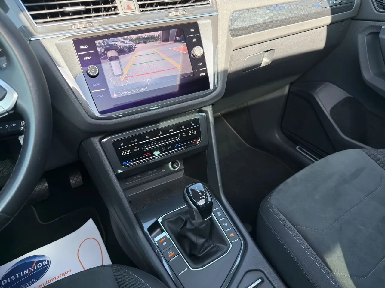 Vue intérieure du Volkswagen Tiguan 2.0 TDI 150 DSG7 Elegance montrant la console centrale avec écran tactile et levier de boîte auto.