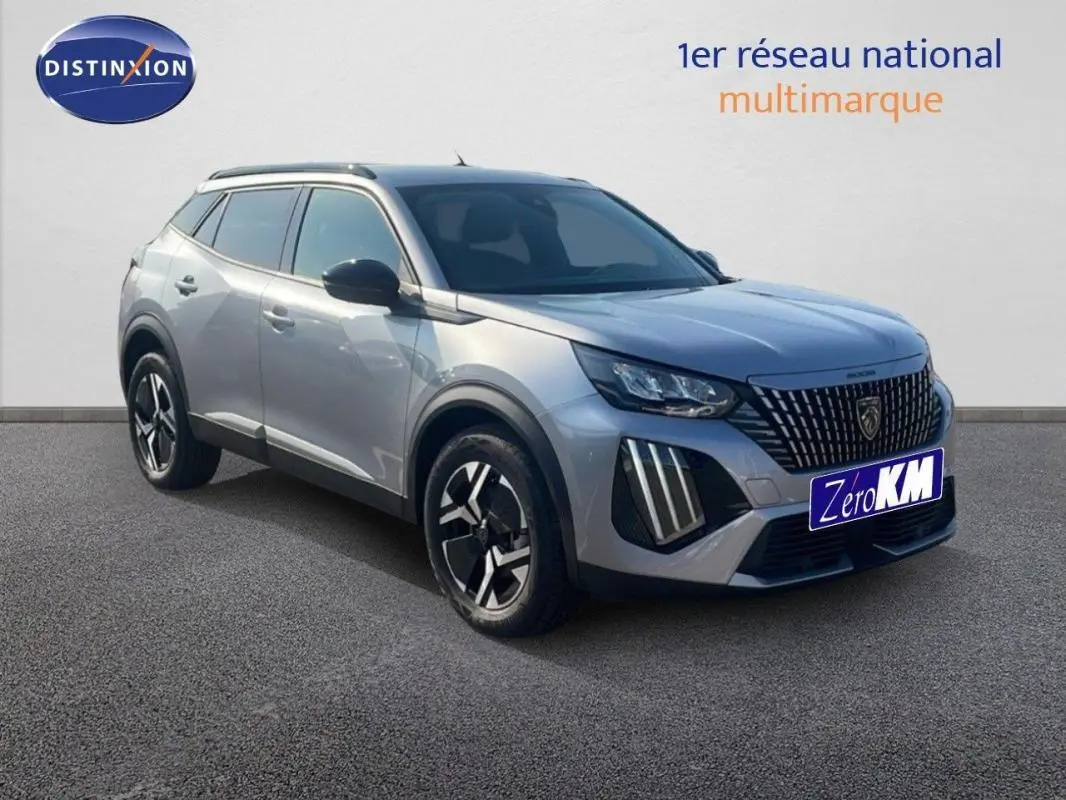 Peugeot 2008 gris en 3/4 avant droit, avec calandre distinctive et jantes aluminium noires et argentées.