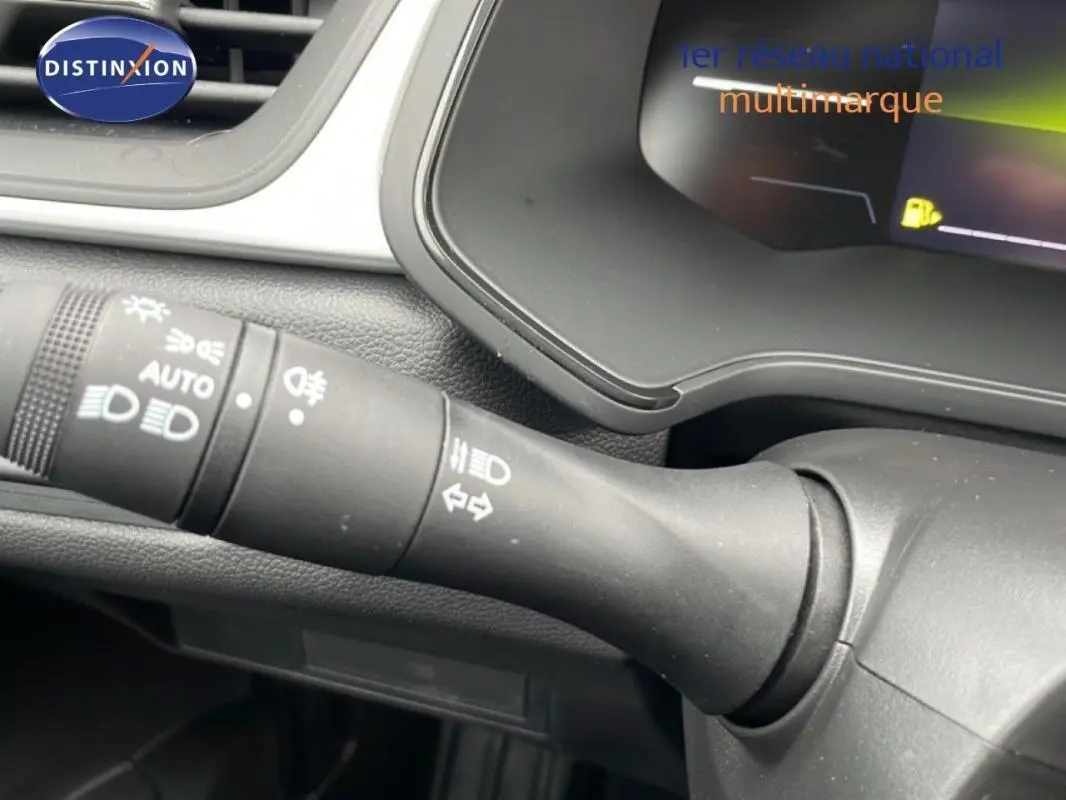 Gros plan sur la commande d'allumage automatique des feux du tableau de bord du Renault Captur noir 2025.