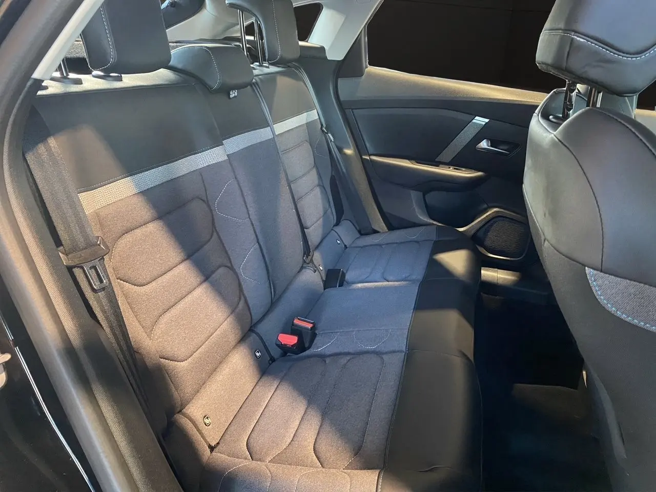 Vue intérieure arrière gauche des sièges arrière gris et noir de la Citroën C4 BlueHDi 130 Plus 2023.
