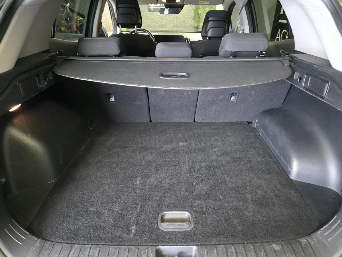 Coffre noir spacieux du Kia Sportage 2022 1.6 T-GDi MHEV avec cache-bagages et sièges arrière rabattables.