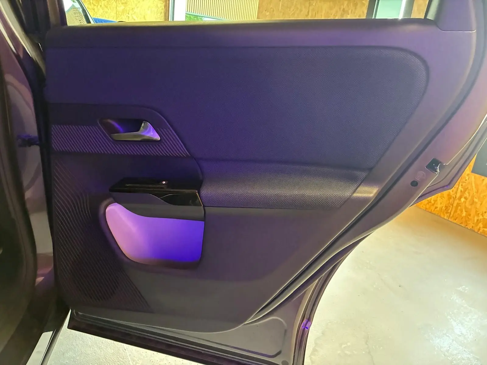 Vue intérieure du panneau de porte arrière gauche du Citroën C5 Aircross gris, avec éclairage violet subtil.