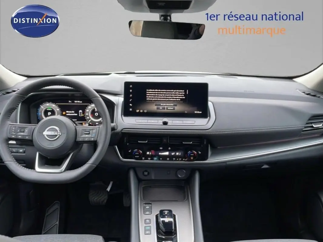 Vue intérieure frontale du tableau de bord noir du Nissan Qashqai blanc 2025 avec écran tactile et volant cuir.