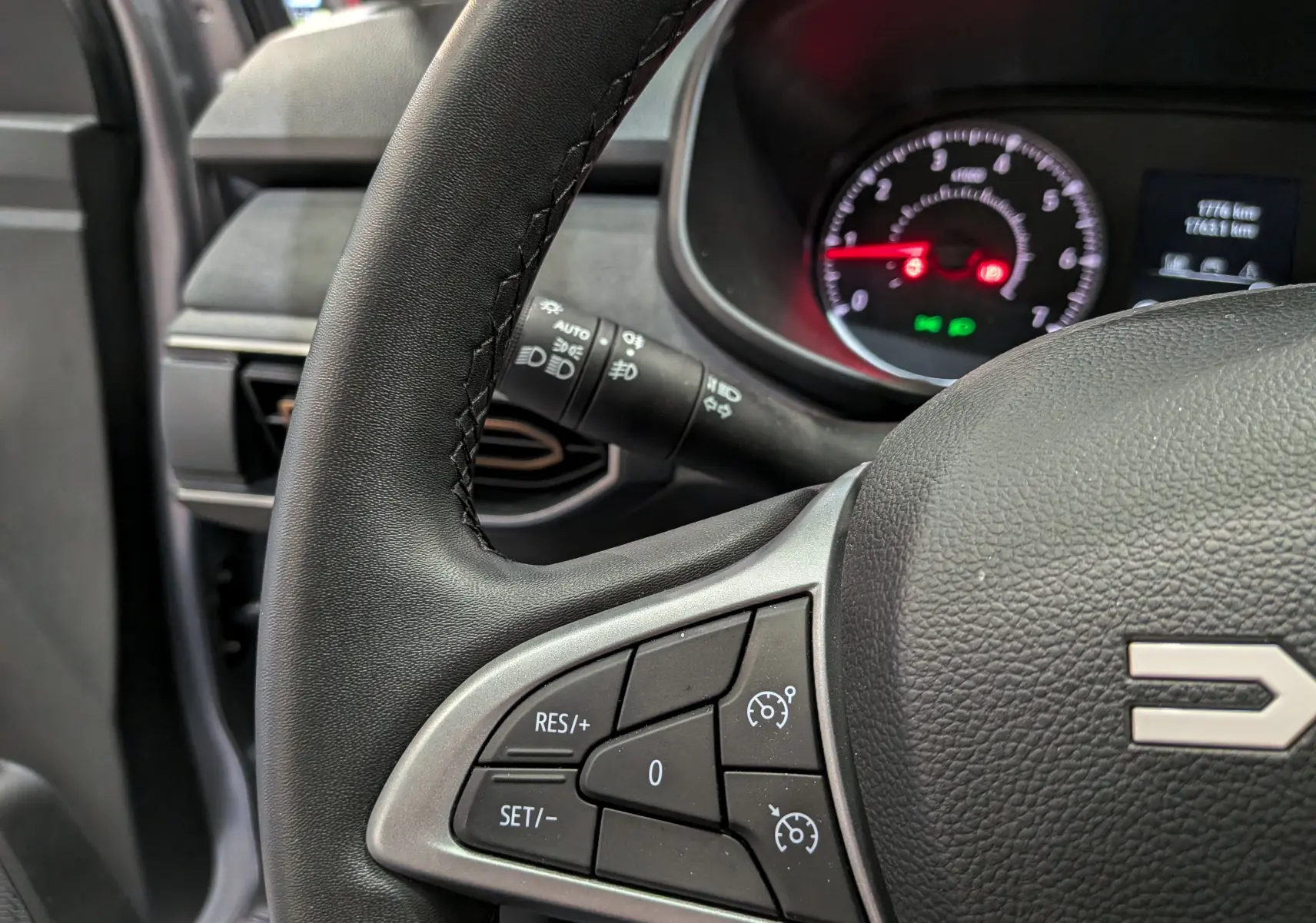 Gros plan sur le volant noir de la Dacia Sandero Stepway 2025, avec commandes de régulateur de vitesse visibles.
