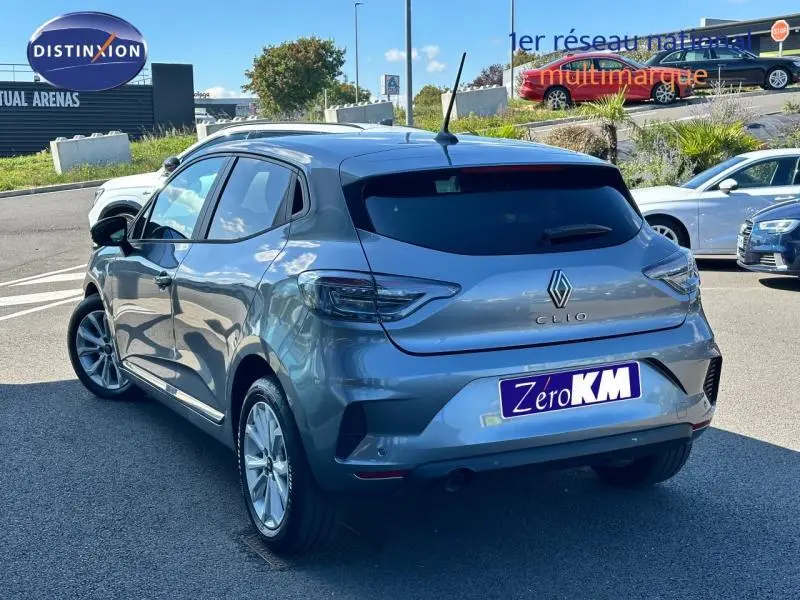 Renault Clio gris Rafale vue 3/4 arrière droit, feux arrière LED et vitres teintées visibles.