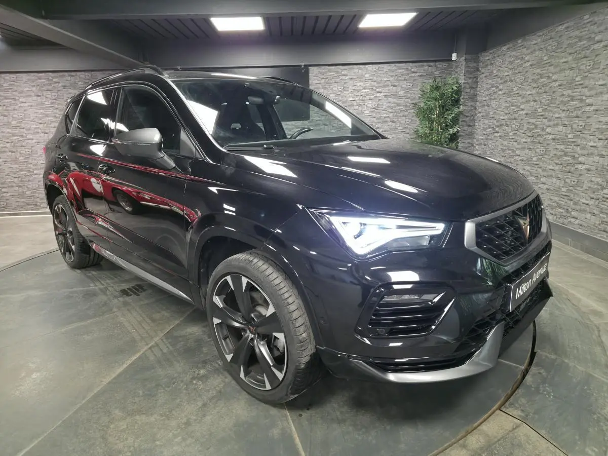 Vue 3/4 avant droite d'une CUPRA Ateca 2024 noire avec jantes alliage noires et signature lumineuse LED distinctive.