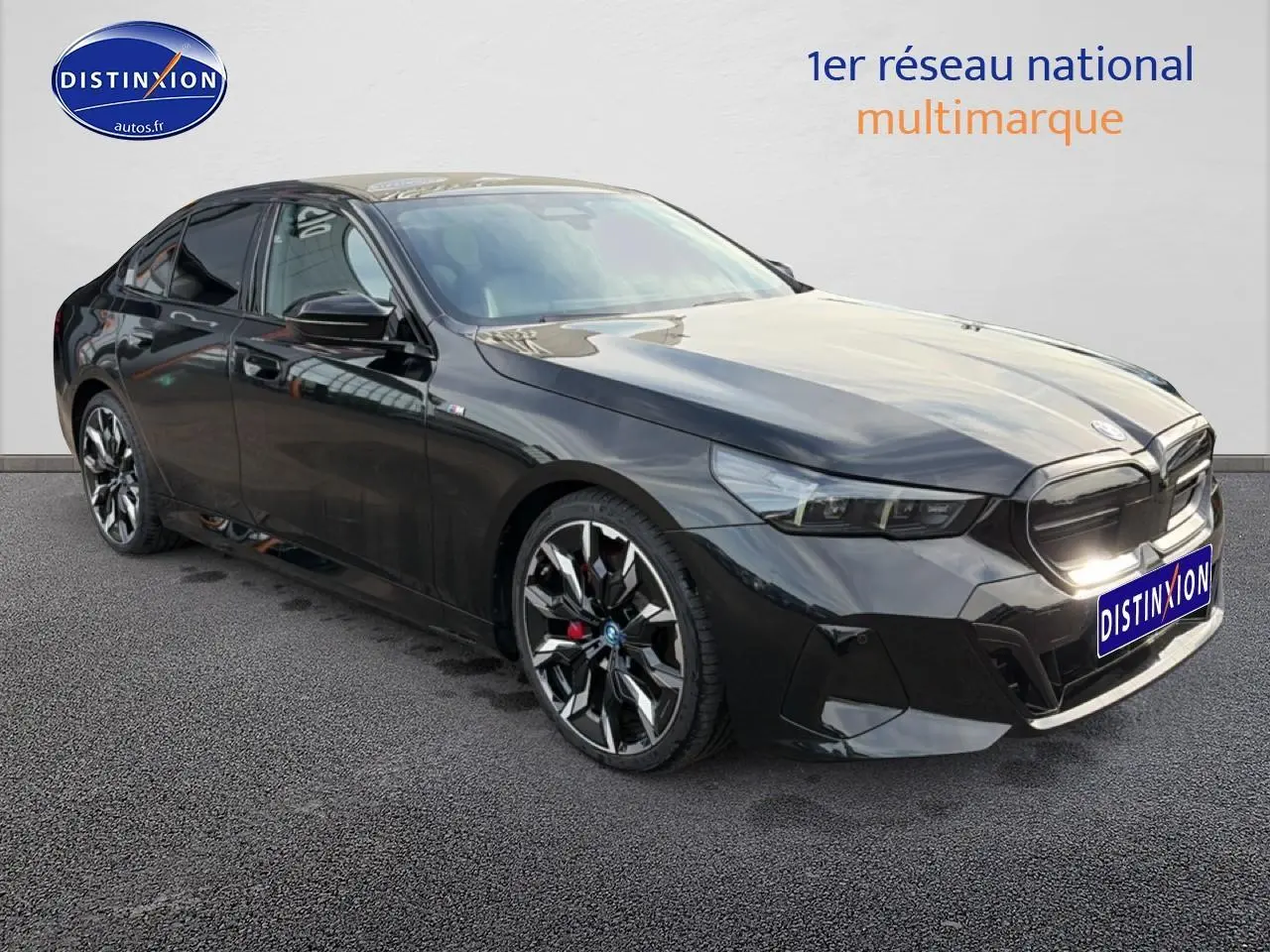 BMW Série 5 i5 M60 noire vue en 3/4 avant droit avec jantes alu bicolores et calandre marquée M.