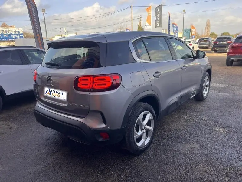 Vue 3/4 arrière droit d'un Citroën C5 Aircross gris Platinium avec feux arrière LED et jantes alliage 18 pouces.