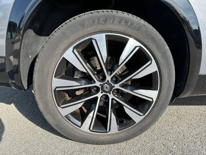 Gros plan sur la roue avant droite du Renault Espace 2024 gris schiste, avec jante alliage bicolore et pneu Michelin.