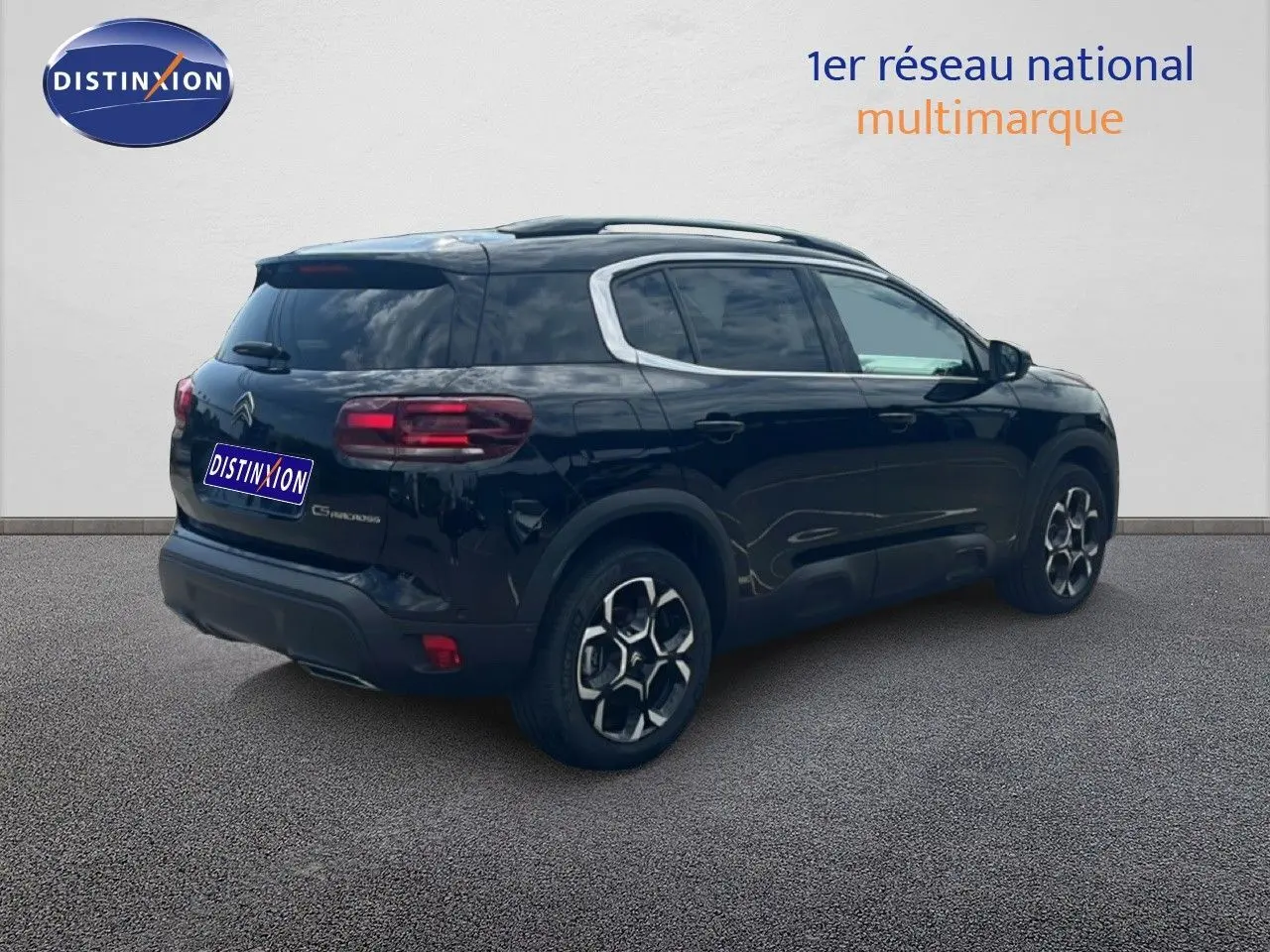 Vue 3/4 arrière droite d'un Citroën C5 Aircross noir métal 2025, hybride essence avec jantes distinctives.