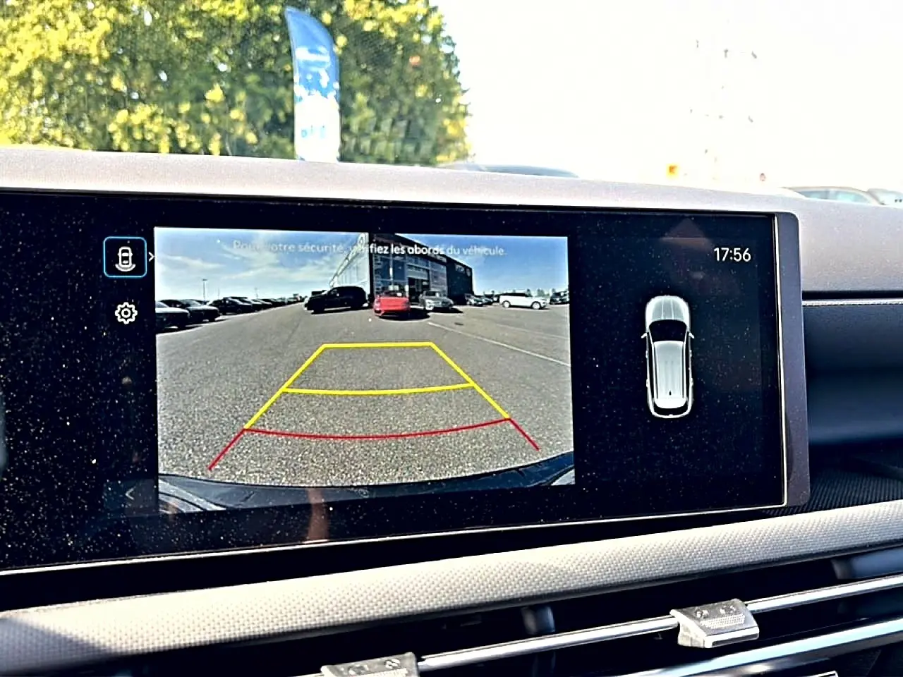 Écran tactile intérieur montrant la caméra de recul du Hyundai Tucson vert hybride, avec affichage des aides au stationnement.