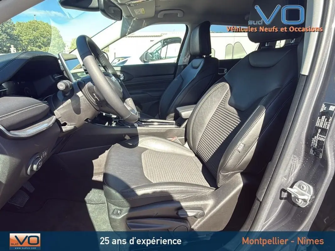 Vue intérieure côté conducteur du Jeep Compass gris 2023, sièges en cuir et tableau de bord moderne avec écran tactile.