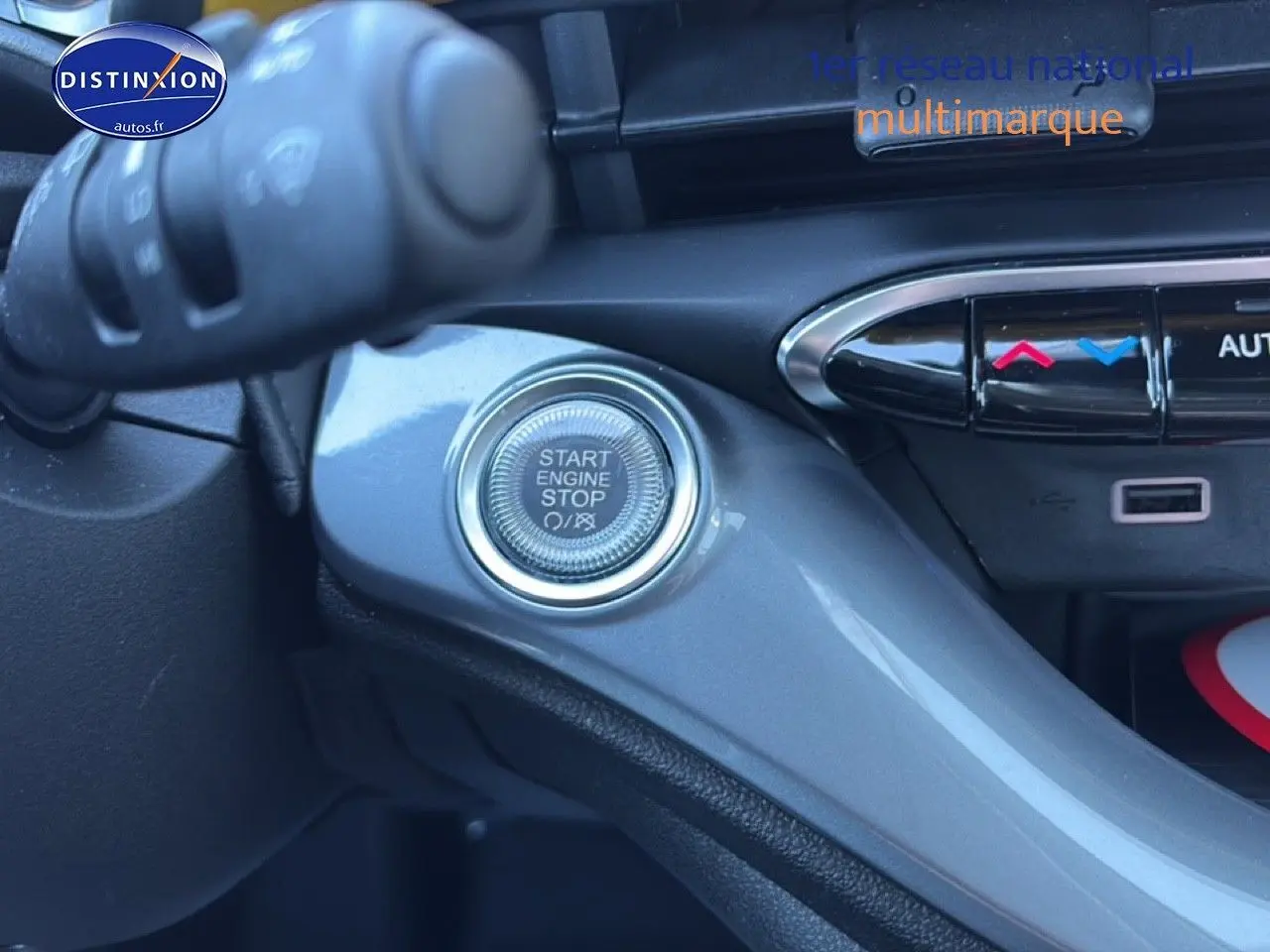 Détail intérieur du bouton Start Engine Stop sur la console grise d'une FIAT 500 hybride Yellow Gold Métal.