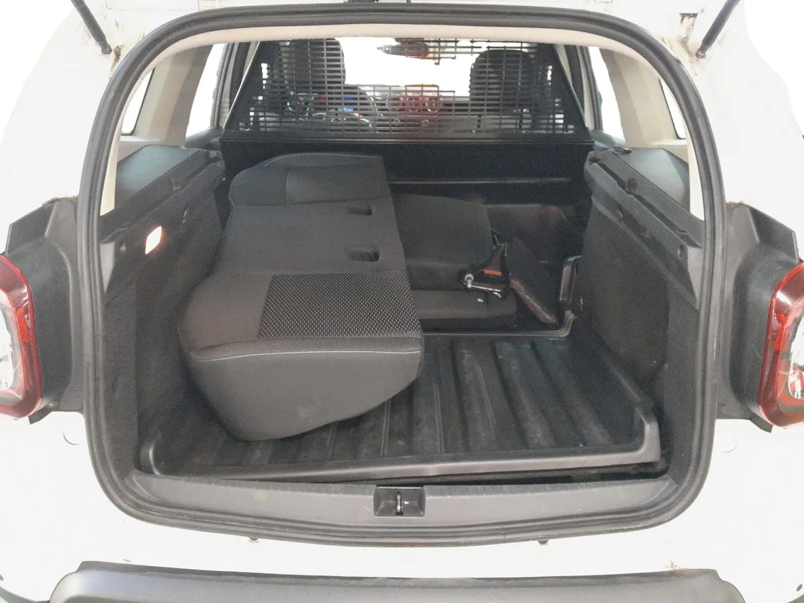 Vue intérieure du tableau de bord et volant noir du Dacia Duster 2021 avec levier de vitesse manuel et commandes centrales visibles.