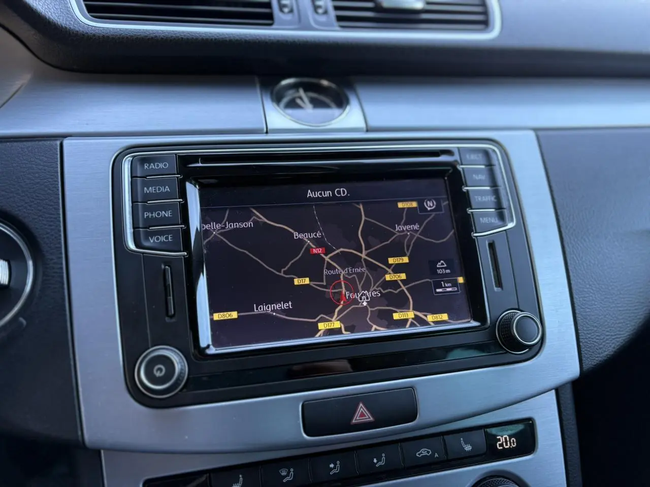 Vue rapprochée de la console centrale de la Volkswagen Passat CC 2015 avec écran de navigation et finition argentée.
