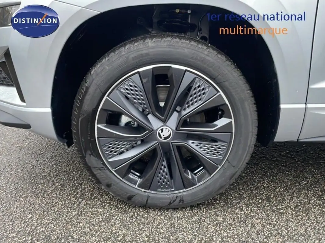 Gros plan sur la roue avant droite avec jante noire et argent du Skoda Karoq argent 2025.