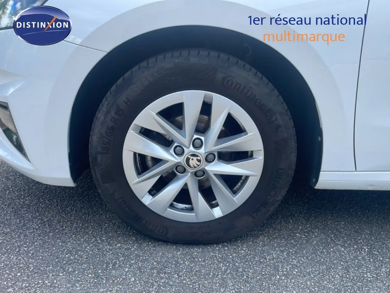Gros plan sur la roue avant gauche d'une Skoda Fabia blanche Candy, mettant en valeur la jante alliage 15 pouces.
