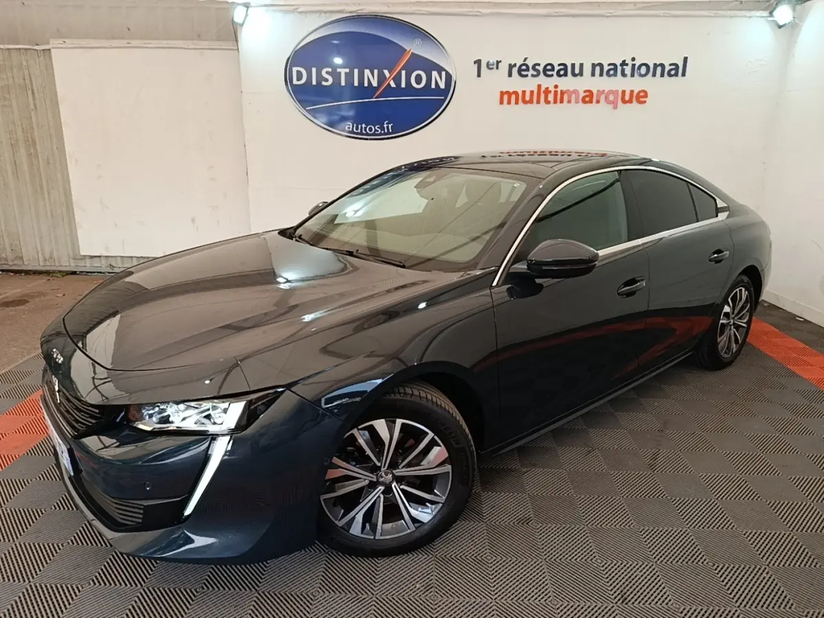 Peugeot 508 gris foncé vue 3/4 avant droit, avec feux LED et jantes alliage distinctives.