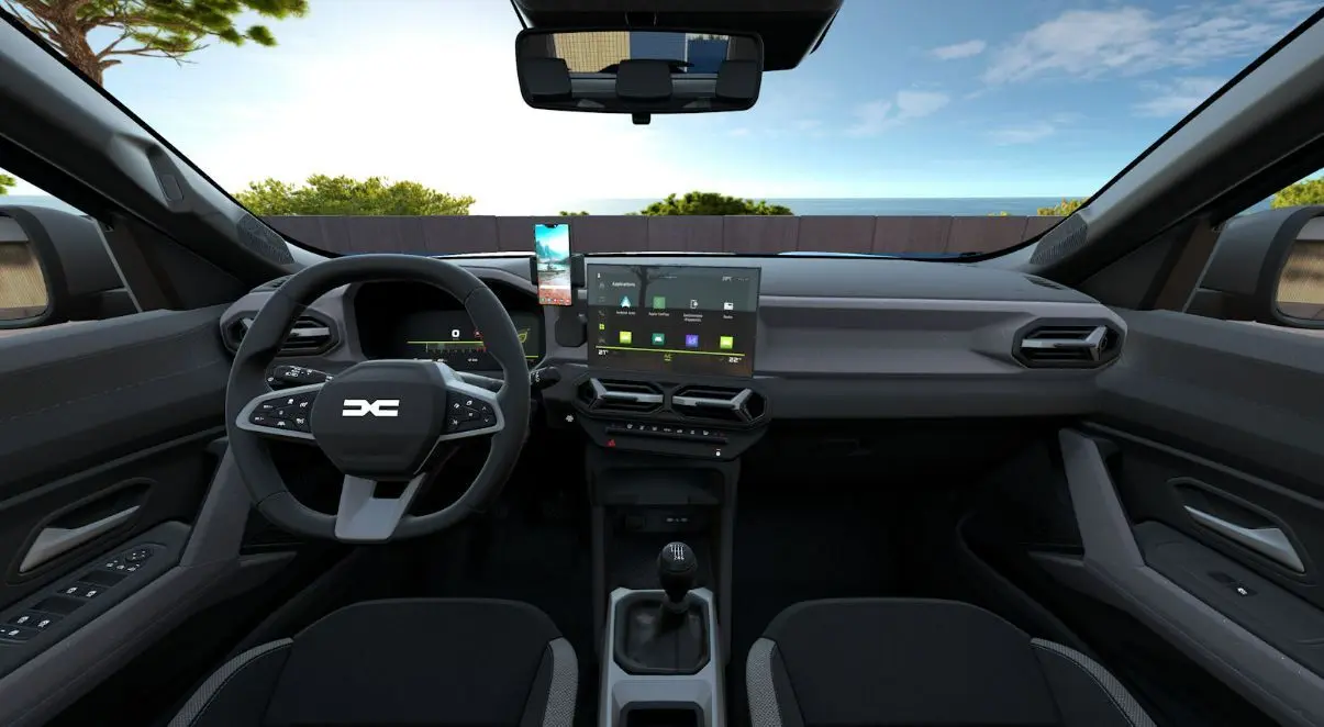 Vue intérieure avant du Dacia Bigster 2026 avec tableau de bord moderne, écran tactile central et volant multifonction noir.