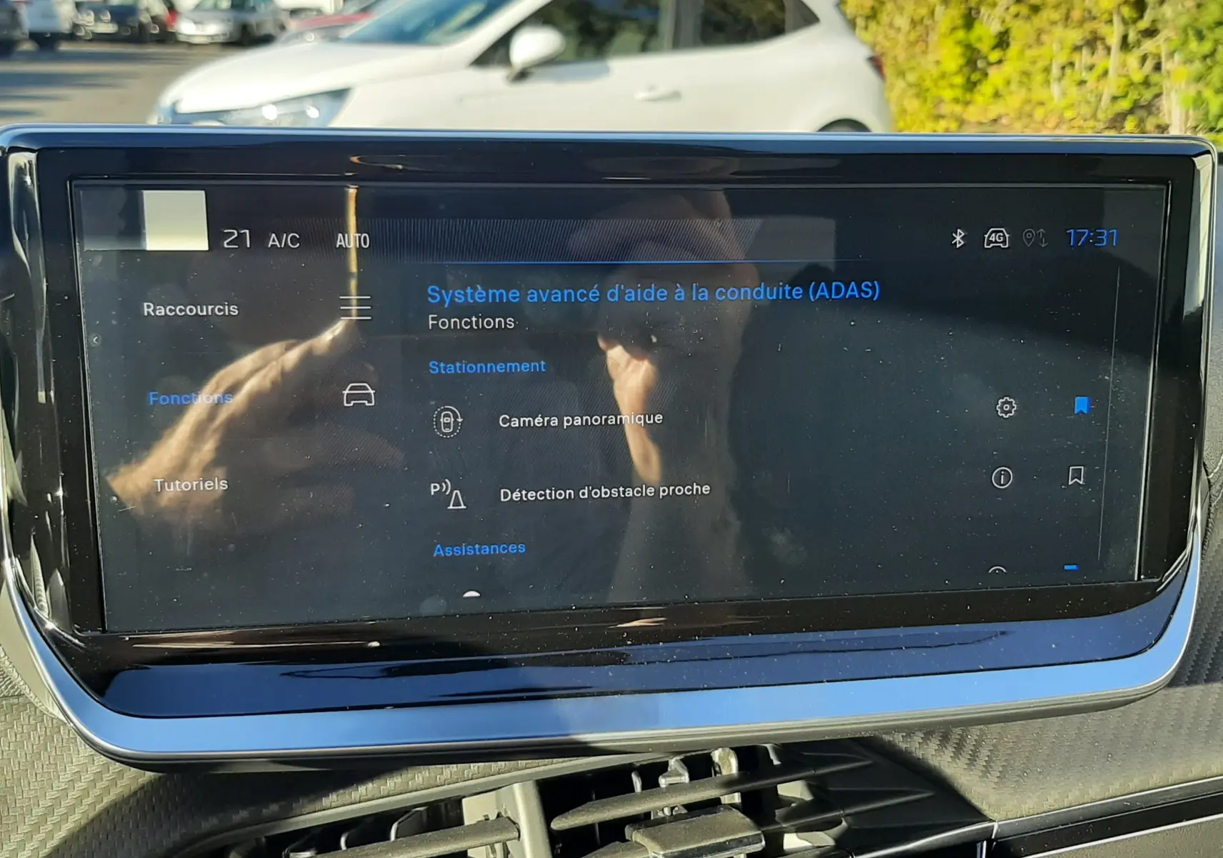 Écran tactile du système d'aide à la conduite affichant les fonctions caméra panoramique et détection d'obstacle sur Peugeot 2008 hybride.