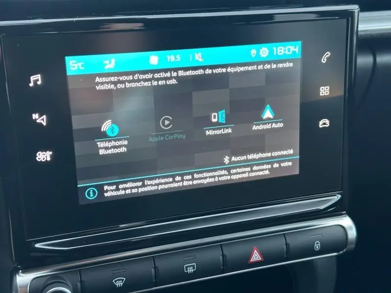 Écran tactile central du tableau de bord du Citroën C3 gris 2023, affichant les options Bluetooth et Android Auto.
