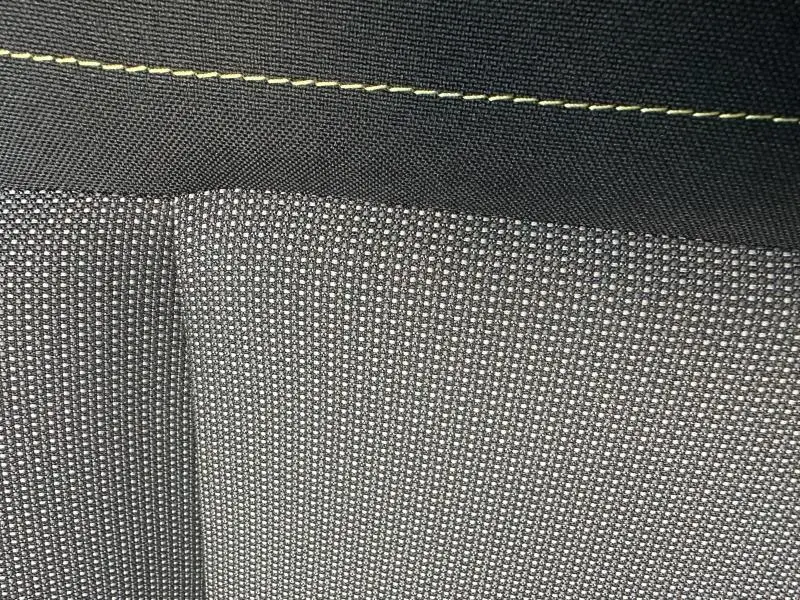 Détail du tissu gris à motifs du siège avant avec surpiqûres jaunes dans une Citroën C3 1.2 PureTech 83ch Shine 2023.