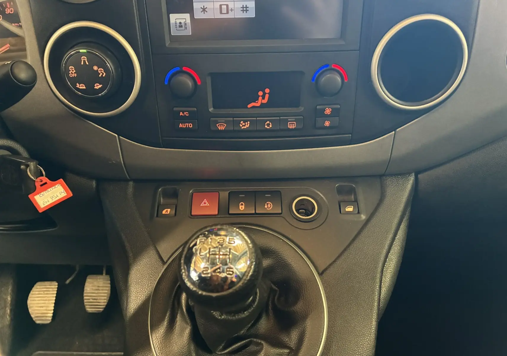 Vue rapprochée de la console centrale du Citroën Berlingo Multispace 2017, avec levier de vitesse manuel et commandes de climatisation.