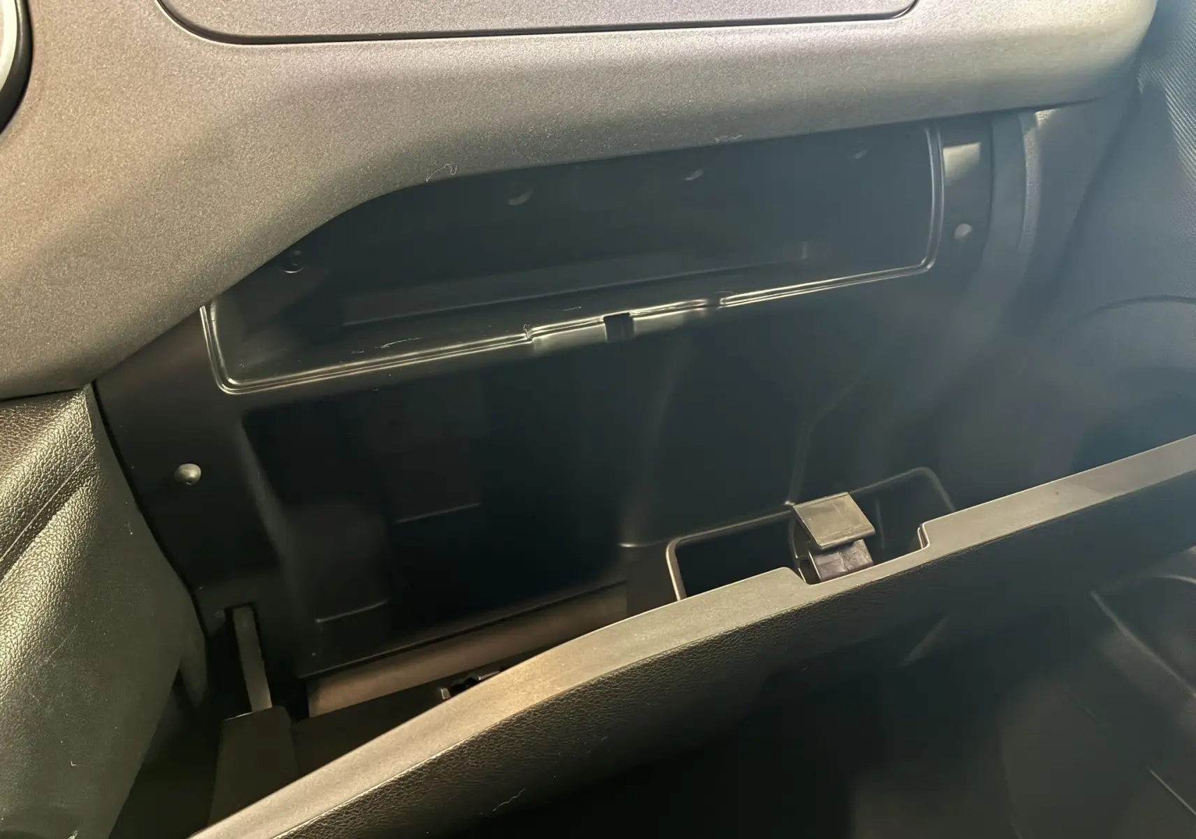 Vue rapprochée de la boîte à gants ouverte côté passager dans l’habitacle noir d’un Citroën Berlingo Multispace 2017.