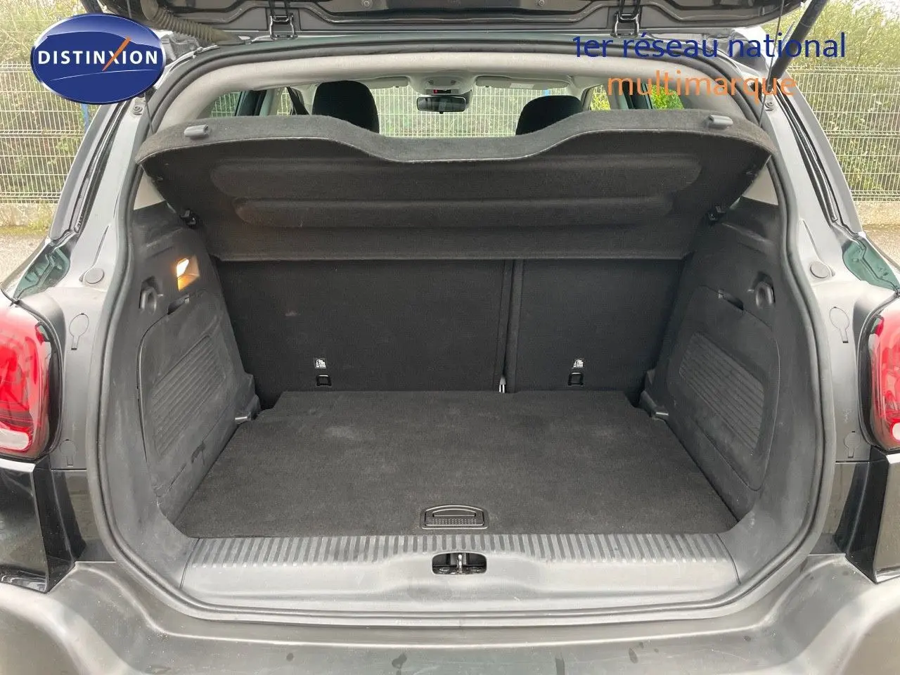 Coffre ouvert vu de l'arrière du Citroën C3 Aircross noir perle métal, montrant un espace de chargement propre et spacieux.
