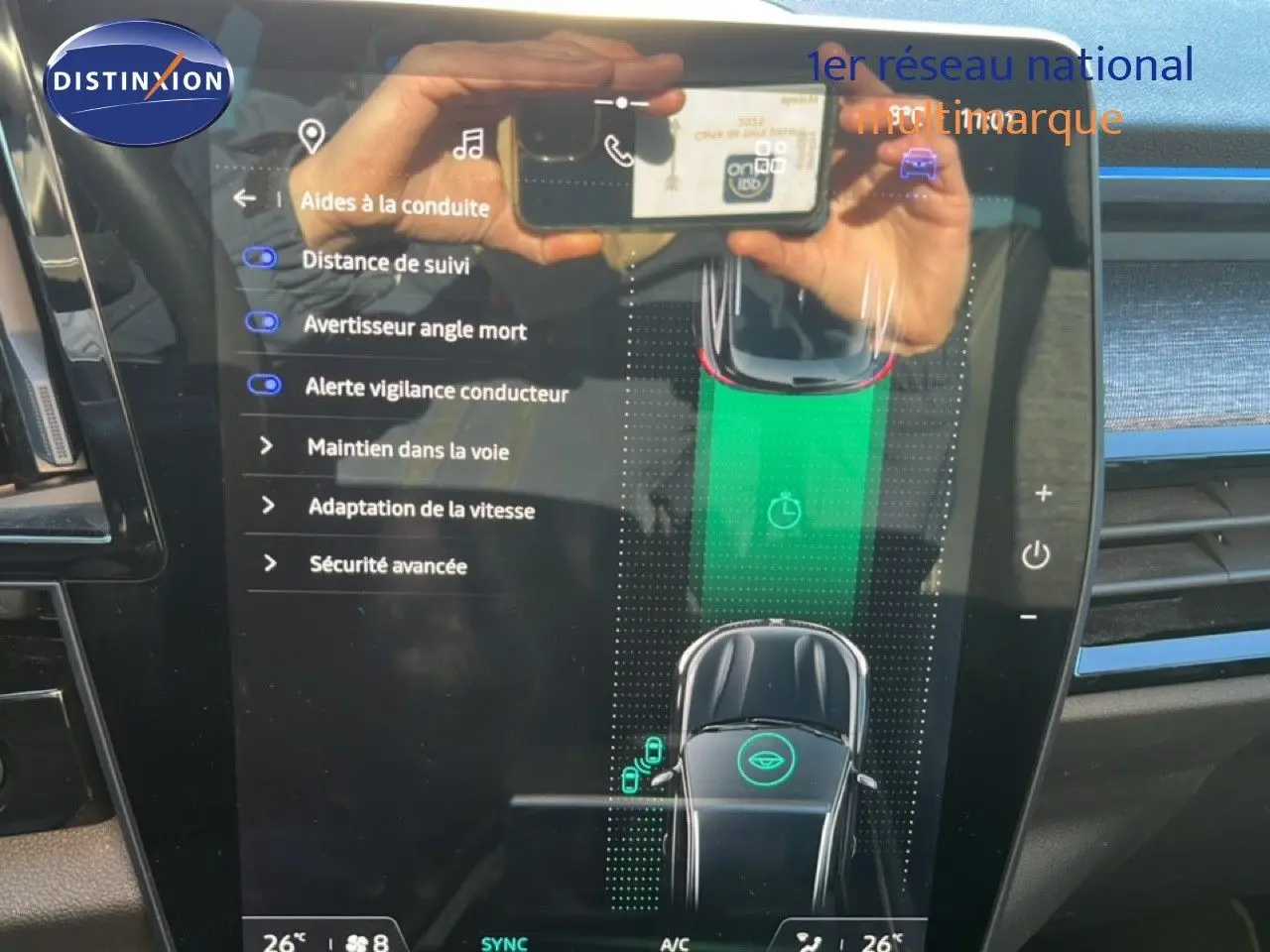 Écran tactile intérieur du Renault Austral noir étoile métal, affichant les aides à la conduite en mode hybride.