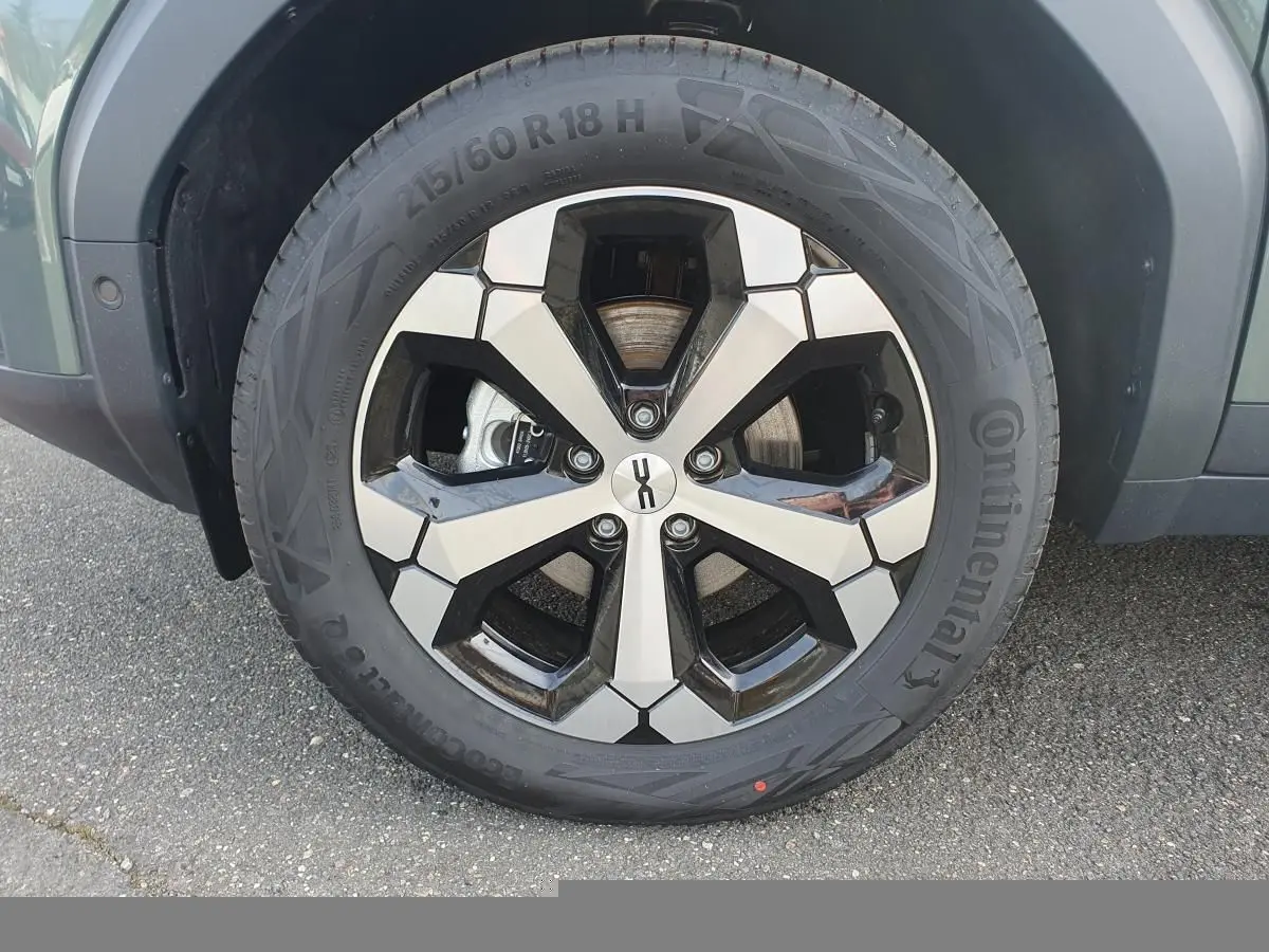 Gros plan sur la jante alliage 18” diamantée Tagasan du Dacia Bigster vert cèdre, avec pneu Continental visible.