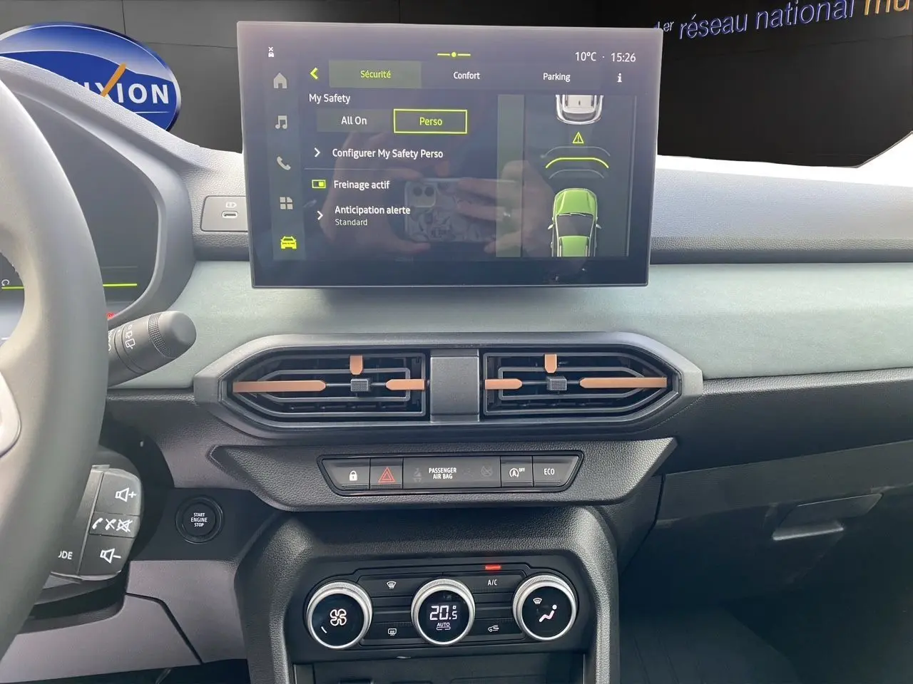 Vue intérieure du tableau de bord de la Dacia Sandero Stepway TCE 110, écran tactile et commandes de climatisation visibles.