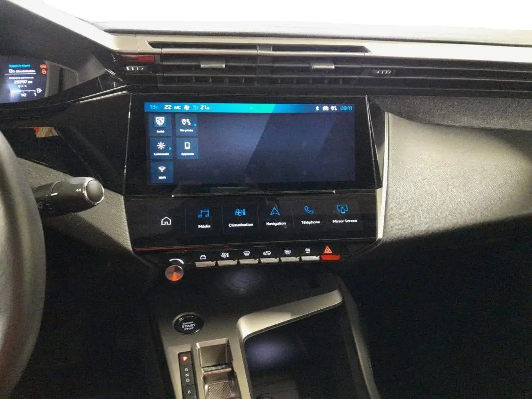 Vue intérieure du tableau de bord et console centrale du Peugeot 408 PHEV 180 e-EAT8 Allure avec écran tactile et bouton start/stop.