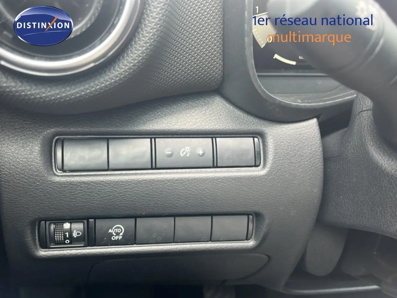 Détail des commandes de réglage d’éclairage et tableau de bord noir du Nissan Juke rouge Fuji Metal 2024.