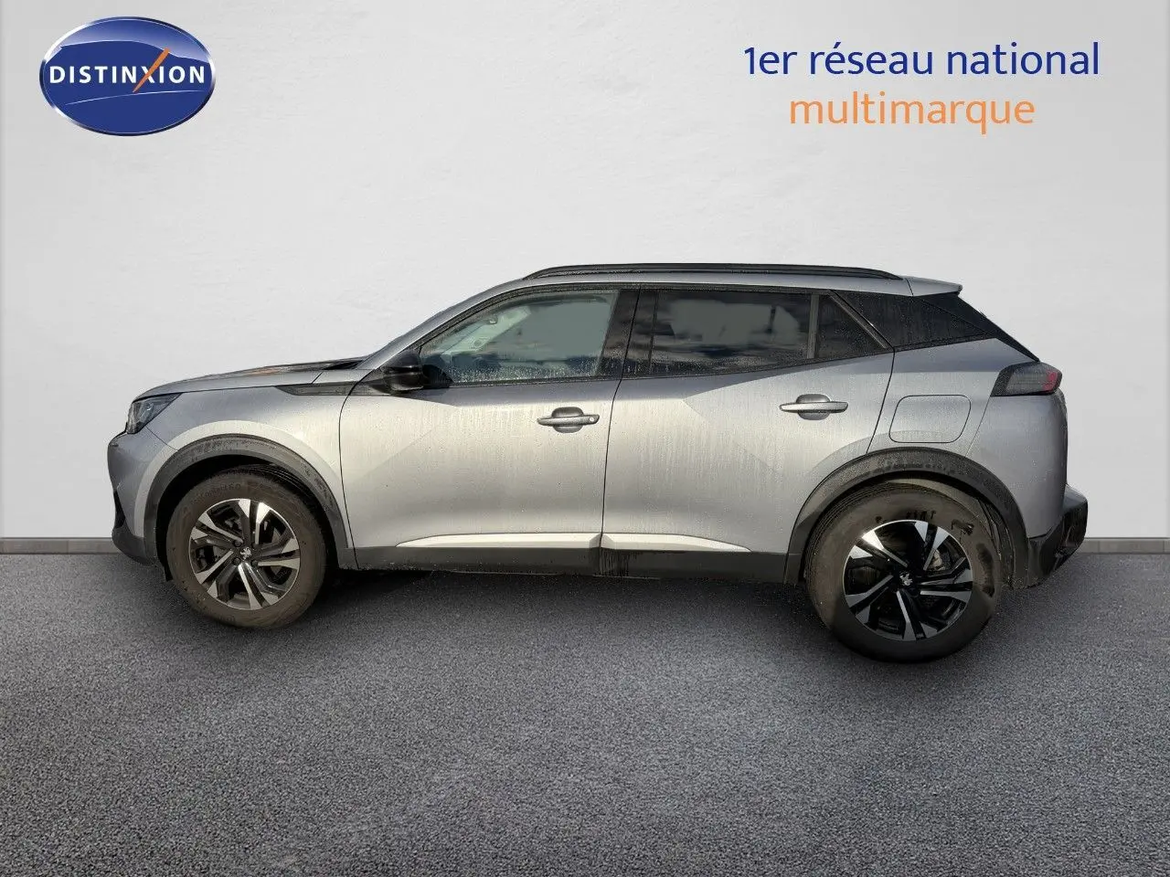 Profil droit du Peugeot 2008 gris Artense 2022, avec jantes noires et toit noir contrastant.