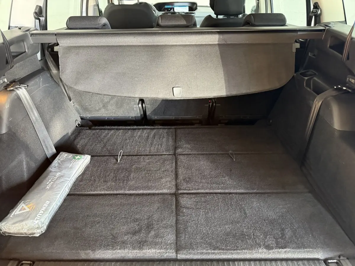 Coffre noir vu de l'arrière du Citroën Grand C4 Spacetourer blanc, plancher plat avec cache-bagages déployé.