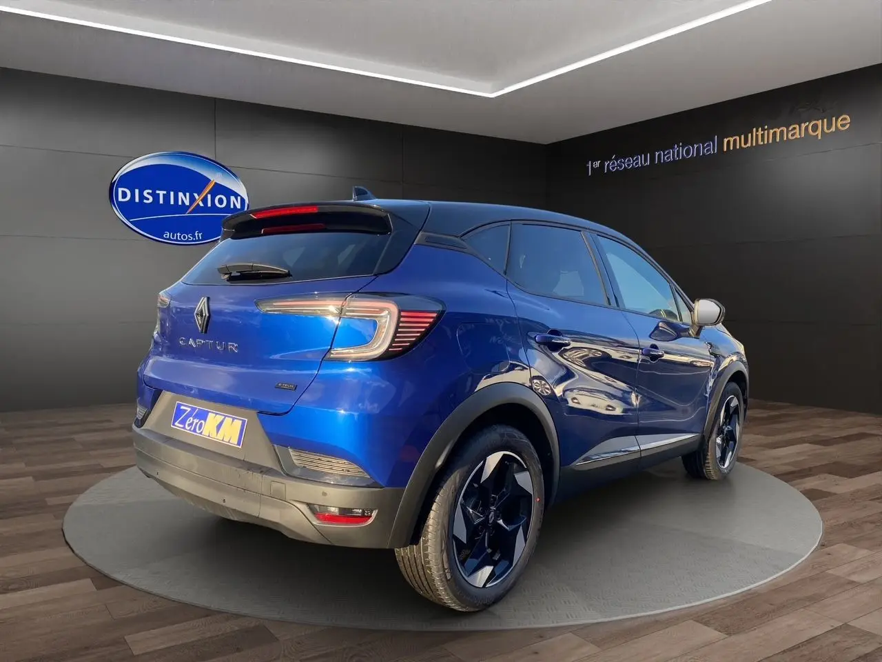 Renault Captur 2025 bleu Iron en 3/4 arrière droit avec toit noir et jantes alliage distinctives.