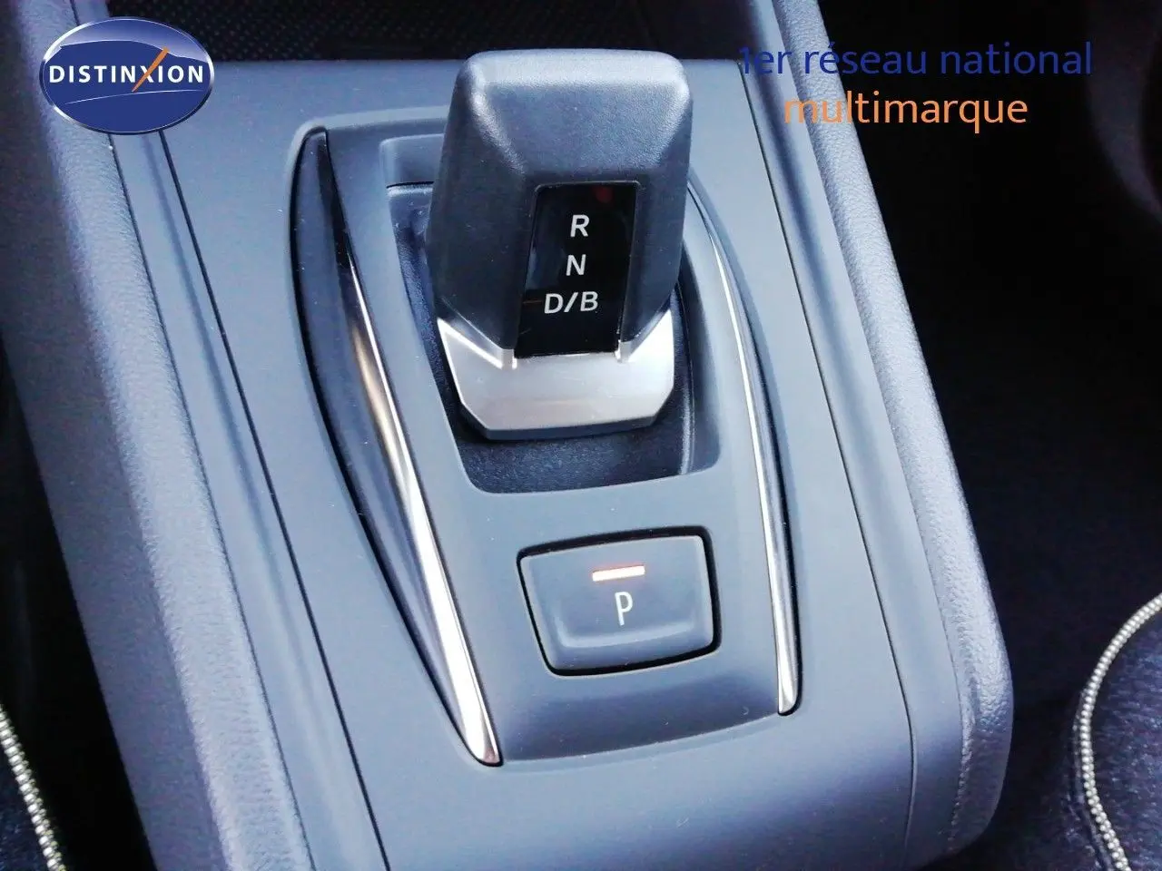 Gros plan sur la commande de boîte automatique du Renault Captur E-Tech hybride, avec bouton de stationnement éclairé.