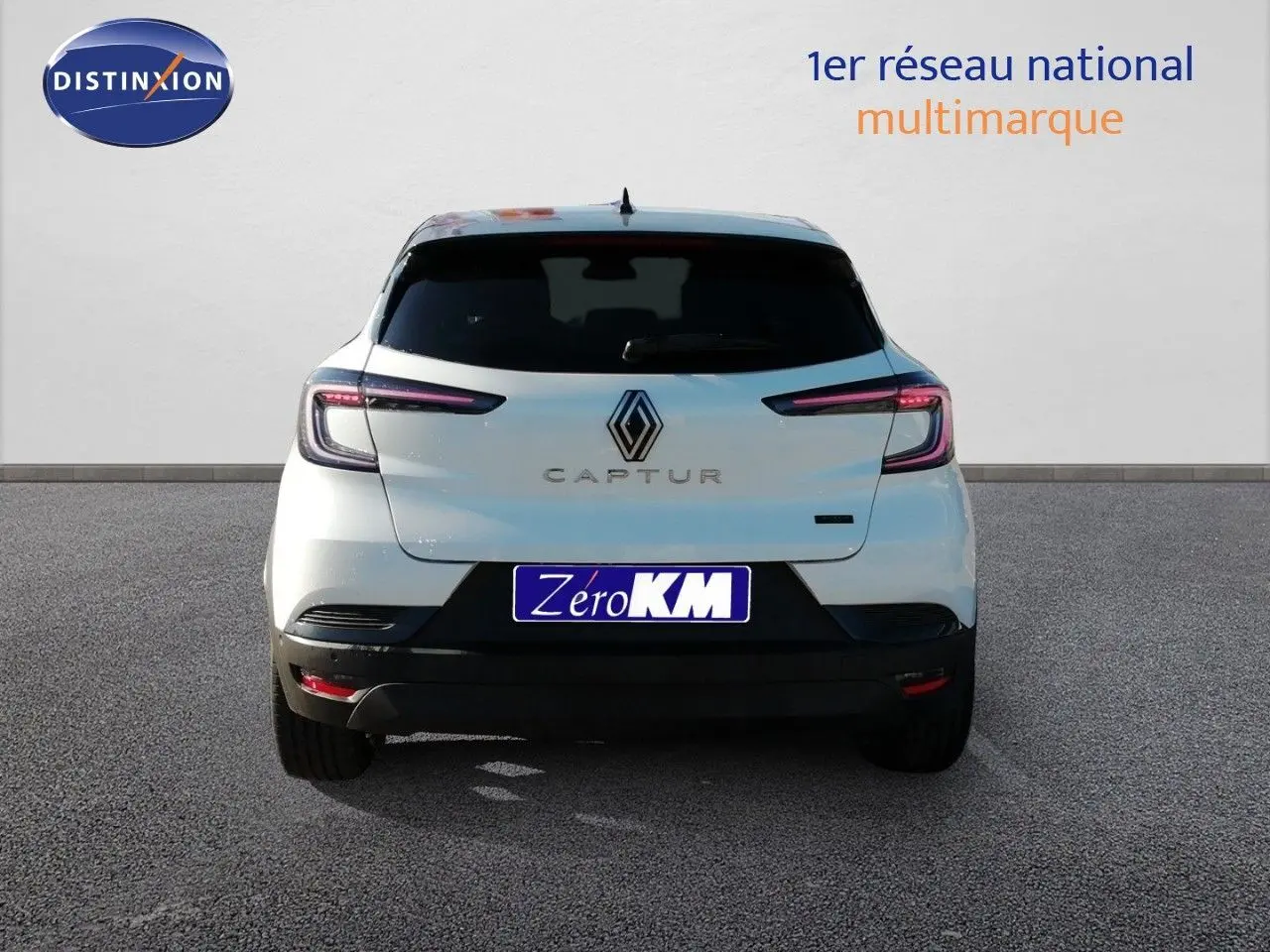 Vue arrière d’un Renault Captur blanc nacré avec toit noir, feux LED et logo central bien visibles.