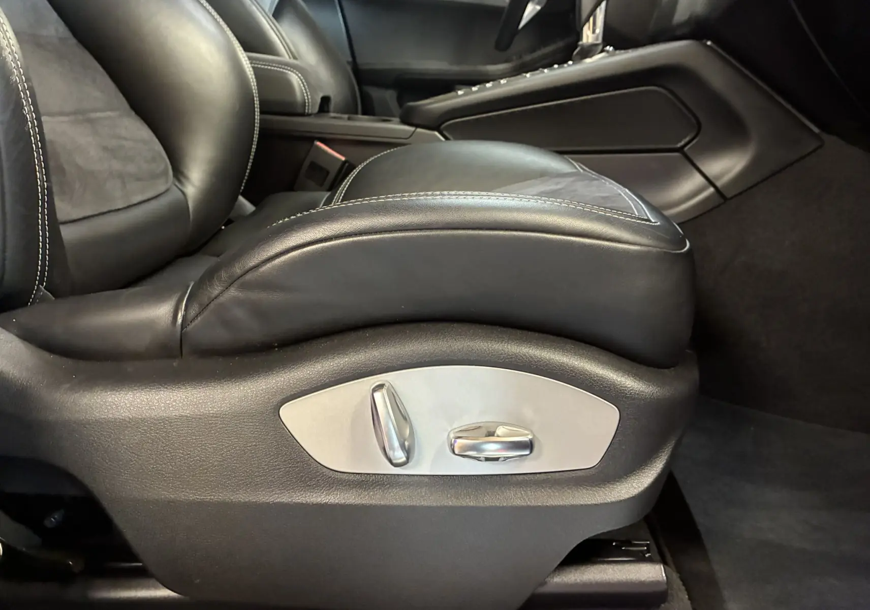 Gros plan sur le siège avant gauche en cuir noir avec commandes électriques intégrées dans une Porsche Macan GTS 2017.
