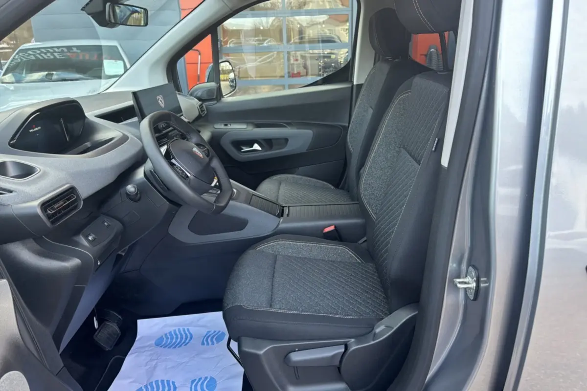 Intérieur avant du Peugeot Rifter gris artense 2026, vue côté gauche montrant sièges tissu et tableau de bord moderne.