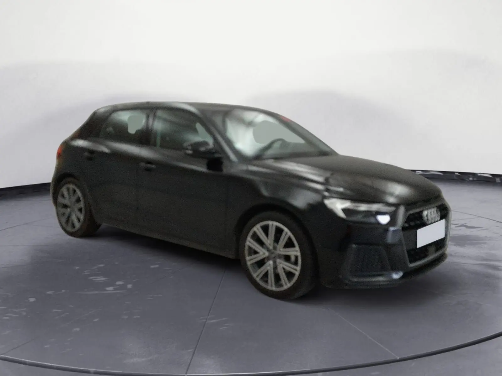 Audi A1 Sportback noir/gris vue 3/4 avant droit, avec jantes alliage et calandre hexagonale distinctive.