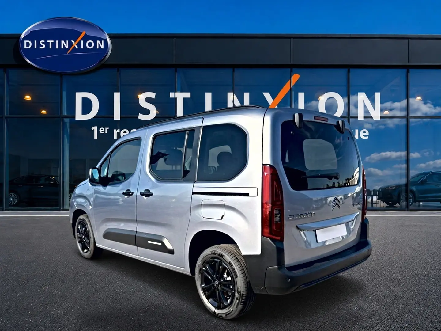 Vue 3/4 arrière droite d'un Citroën Berlingo Steel Grey 2026 avec jantes noires et vitres teintées.