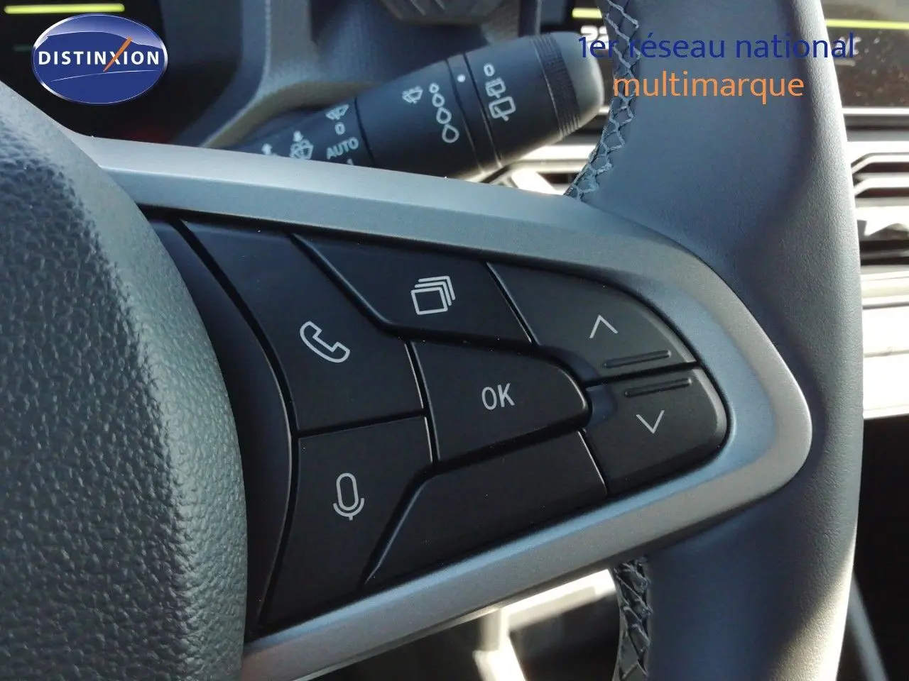 Gros plan sur les commandes multifonctions du volant en cuir gris noir du Dacia Duster TCE MHEV 140ch Journey 2026.