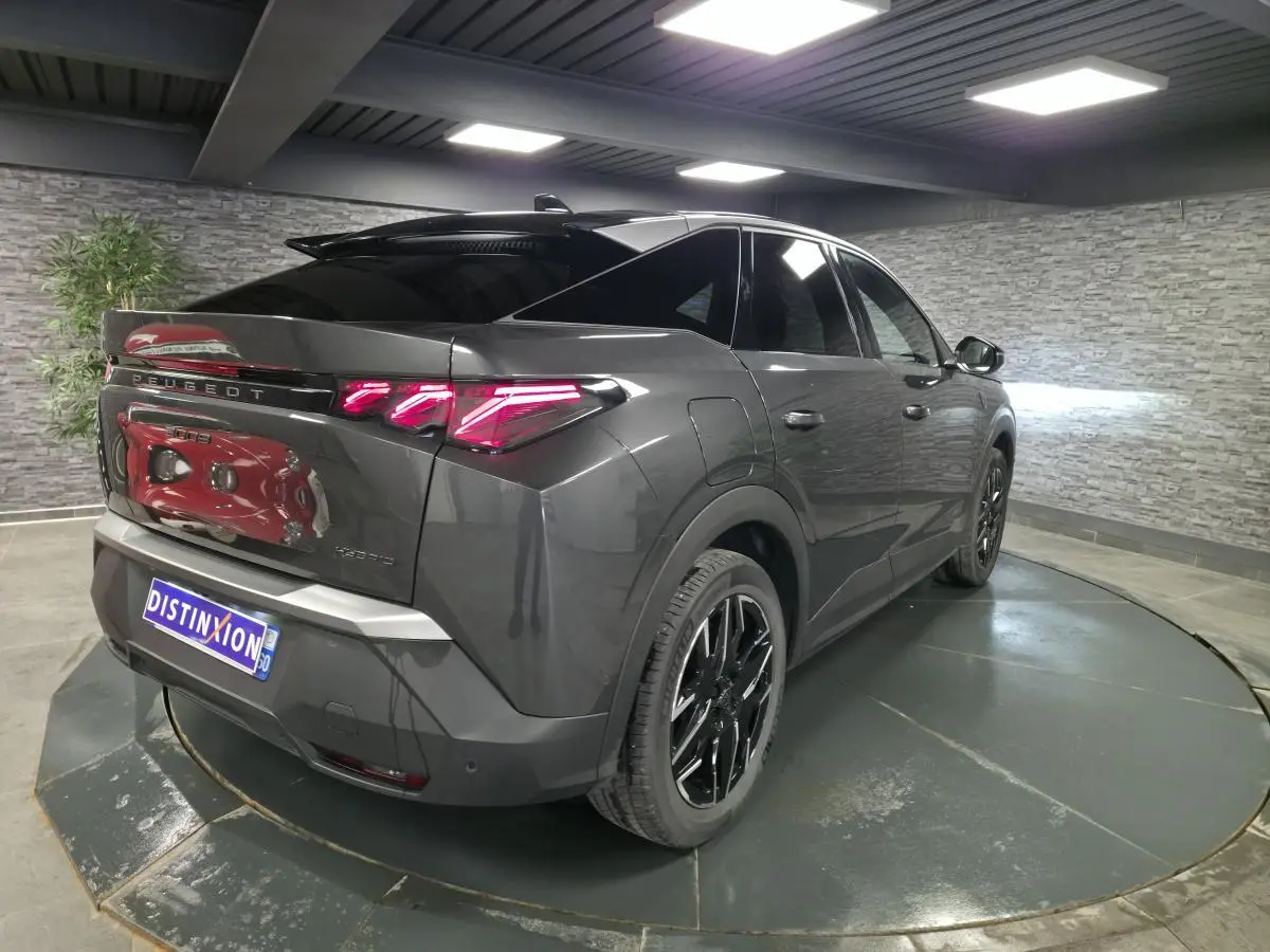 Vue 3/4 arrière droite d’un Peugeot 3008 gris métallisé avec feux arrière à griffes LED et jantes alliage noires.